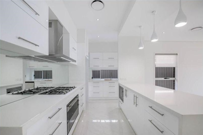 The house kitchen renovation project in Oatley comes with custom size cabinets, with classic plain metalic white polyurethane finish door with pencil edge and soft-closing hardwares. The benchtops colour is in diamond white,thickness is 40mm. Comes with free silver handles.